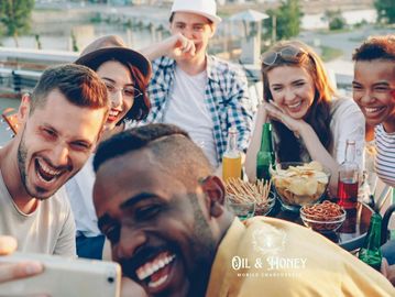 A diverse group of friends joyfully taking a selfie outdoors.