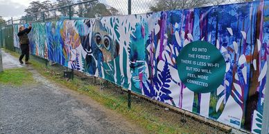 Colorful forest-themed banner with a message about nature and connection.