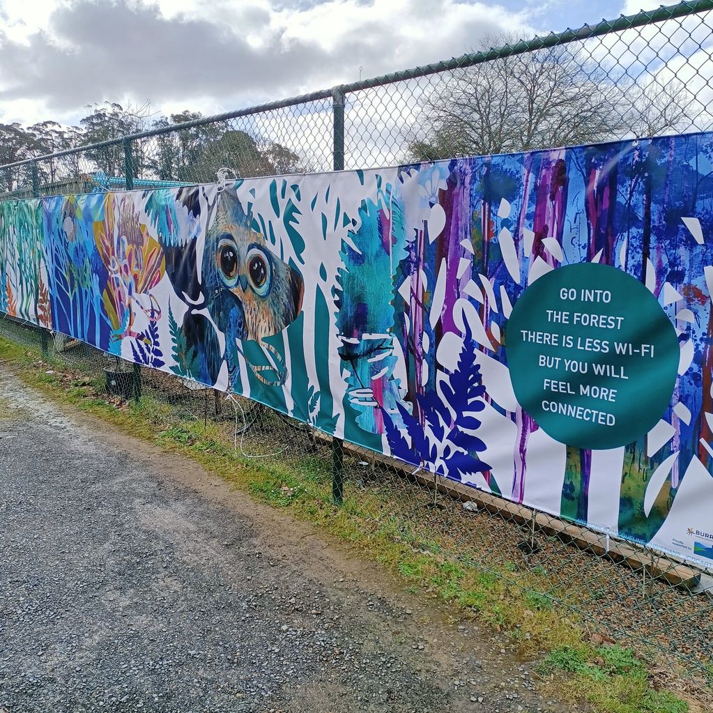 Colorful forest-themed banner with a message about nature and connection.