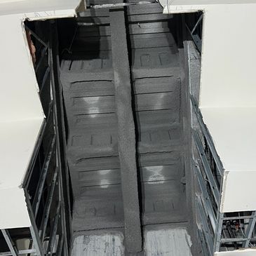Close-up of an industrial chute or conveyor inside a large machine.
