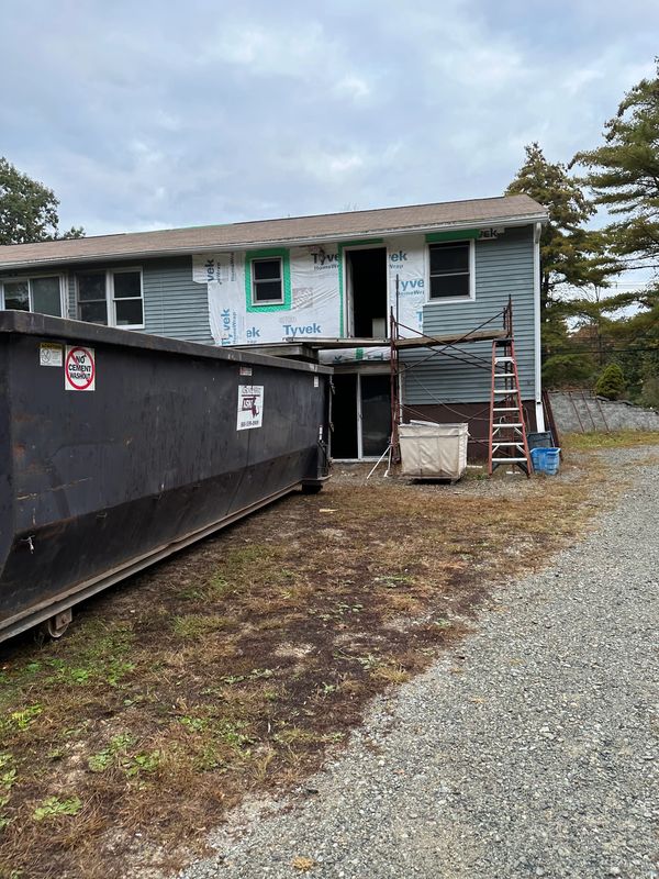 House under renovation with scaffolding and construction materials.