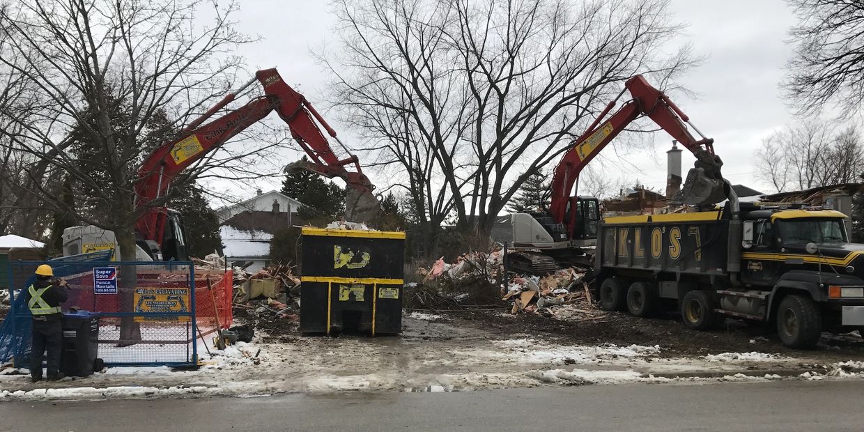 Loading waste into truck and dumpster