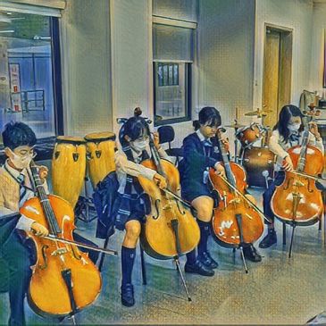 Children playing cellos in a school music room.