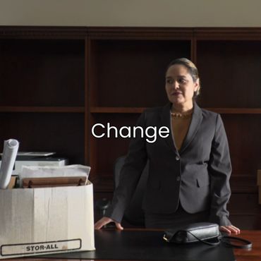 Professional woman standing confidently in an office with the word 'Change'.