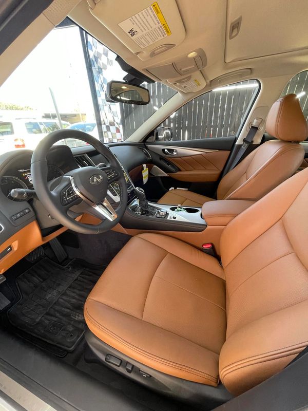 A car with tan leather seats and brown trim.