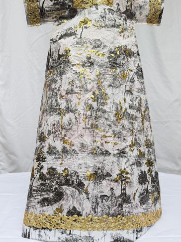 Elegant dress with intricate landscape and floral print.