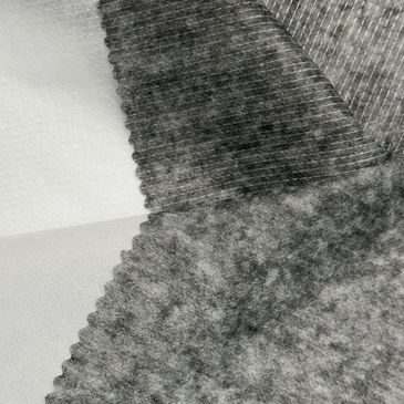 Close-up of layered fabric swatches with different textures and patterns.