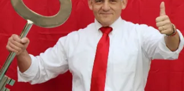 Man hold the key with thumbs up and looking on the camera