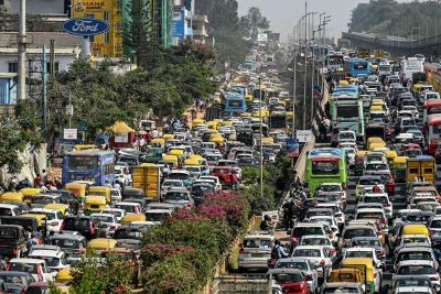 Heavy traffic congestion on a busy city road with cars and buses.