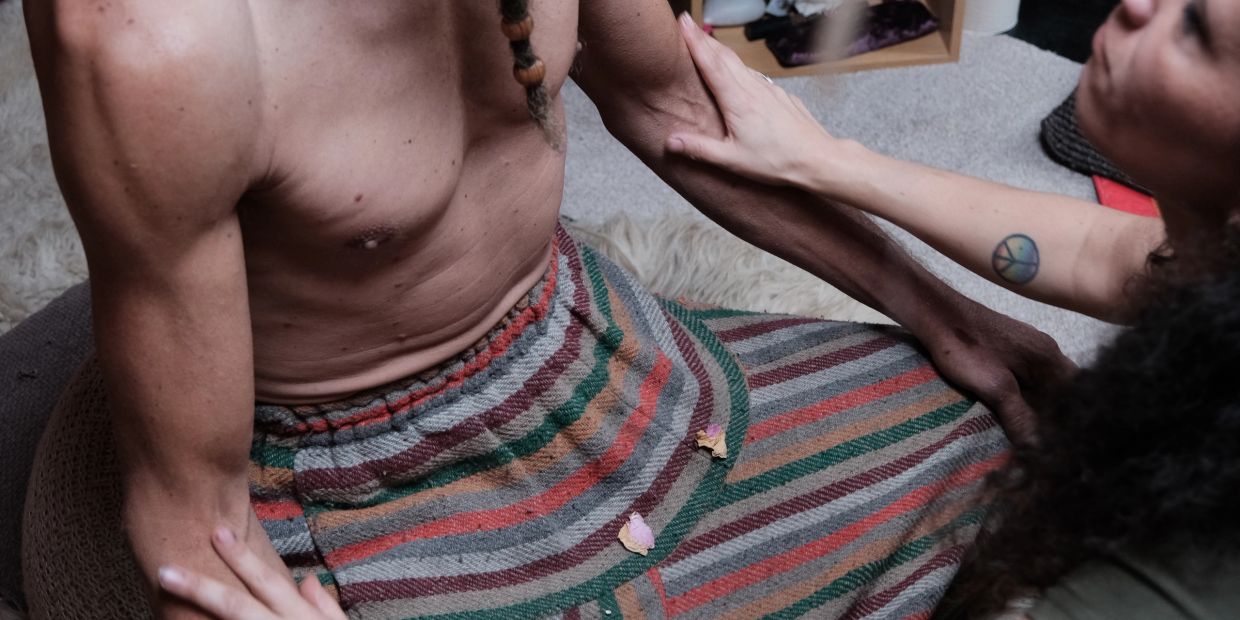 Person touching another person's arm showing care.