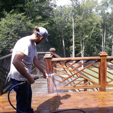 Southern Home Handyman pressure-washing wood deck.