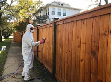 Southern Home Handyman in Richmond, VA Staining a wood fence using Ready seal water sealant.