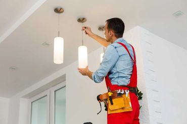 Southern Home Handyman installing modern light fixture in home in Richmond, Virginia.
