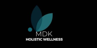MDK Holistic Wellness logo with green leaves on black background.
