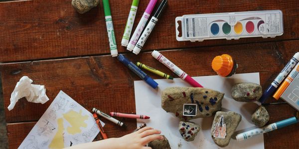 Markers, paints, rocks, crayons, paper and little hands show how fun youth art programs can be.