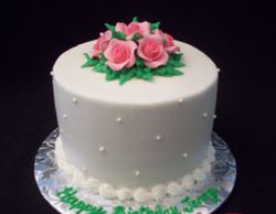 Double layer cake with sugar pearls and roses.