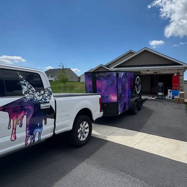 Star coatingz with galaxy-themed trailer parked in a driveway on a sunny day. Star Coatingz set up and ready to install a durable and decorative flake system. 