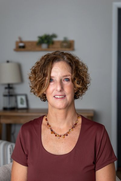 Portrait of a woman with curly hair indoors.