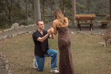 Man proposing to woman outdoors.