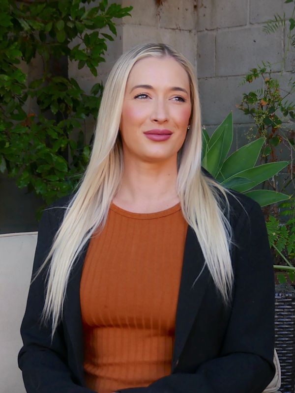 a therapist looking off camera wearing a black jacket