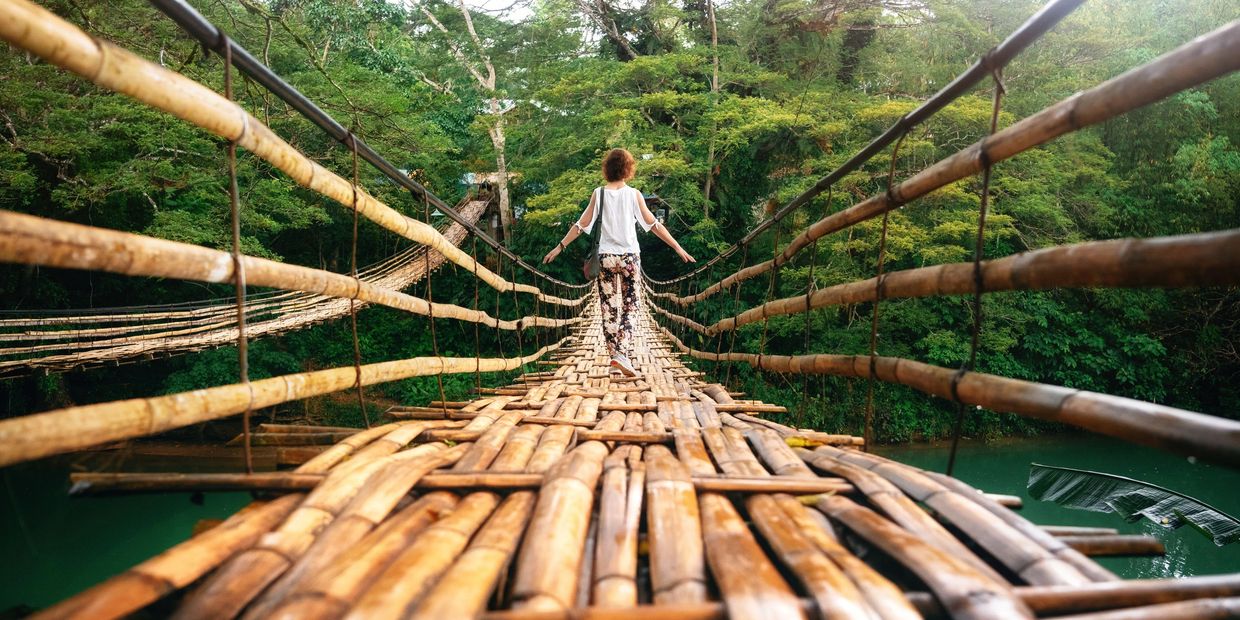 Lady crossing bridge mind body therapy connection