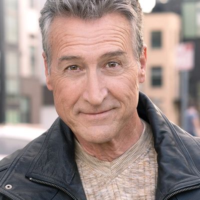 Smiling middle-aged man in leather jacket.