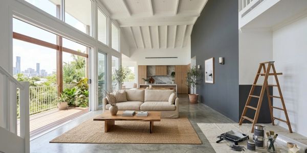 Bright modern living room with large windows and city view.