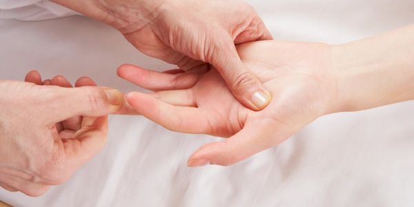 Someone receiving hand reflexology