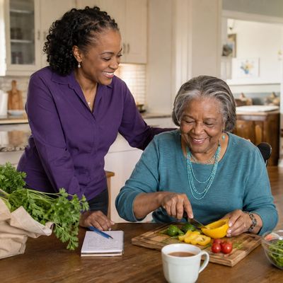 Non-medical companion assisting an older adult with meal preparation.

