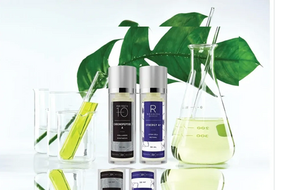 Skincare serums with green plant and lab glassware, highlighting natural and scientific beauty.
