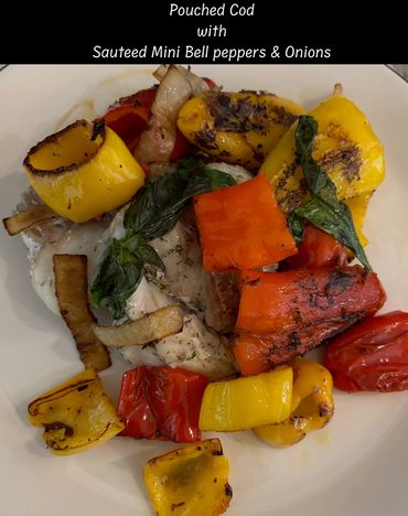 Pouched cod with sautéed mini bell peppers and onions on a white plate.