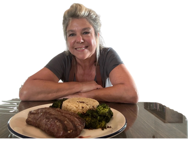 A woman smiling at a table with a plate of steak, rice, and broccoli.
