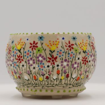 Colorful floral-patterned ceramic bowl with a dotted rim.