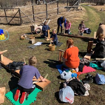 group of children learning bushcraft skills together