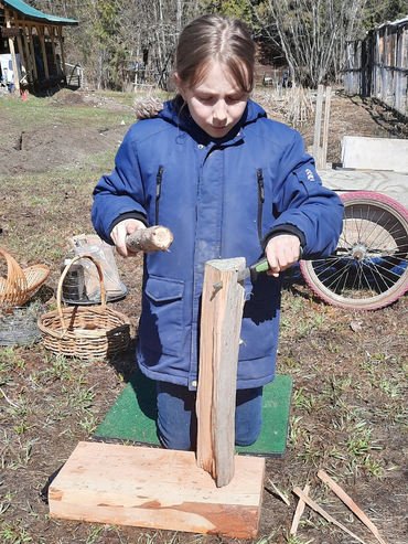 teen batoning a piece of fire wood