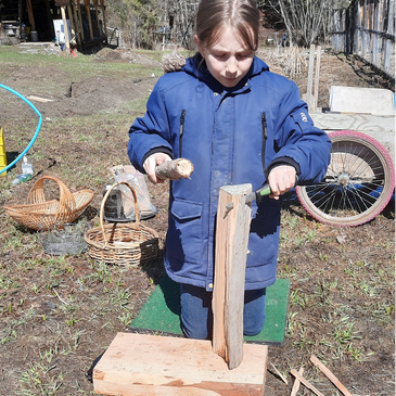 child practicing batoning to create kindling