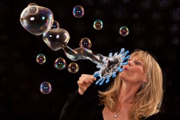 Rebecca the bubble lady blowing bubbles.