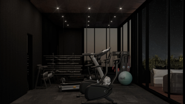 Gimnasio moderno con máquinas y luces tenues de noche.