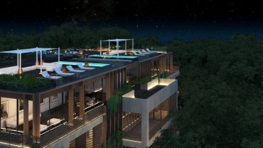 Edificio moderno con terraza iluminada y piscina en la azotea de noche.