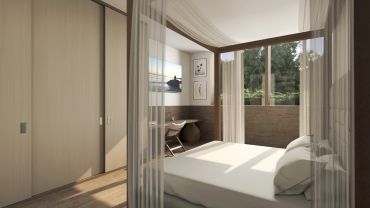 Dormitorio iluminado con ventana grande y escritorio.