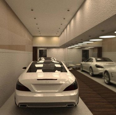 Interior de un garaje moderno con autos blancos estacionados.