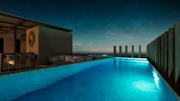 Piscina iluminada y moderna durante la noche.