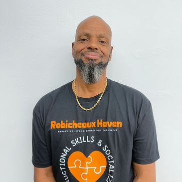 Man wearing a black t-shirt with a logo and text.