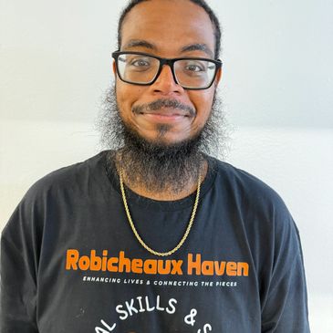 Man with glasses and a beard wearing a Robicheaux Haven shirt.