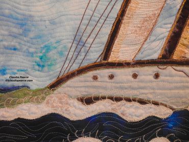 Detail of a ketch in choppy seas with the sails billowing out. 