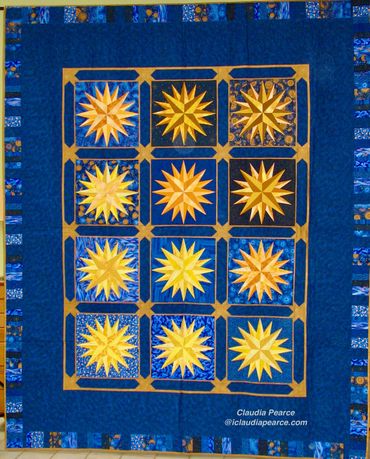 Quilt of gold mariner's compass blocks on blue background