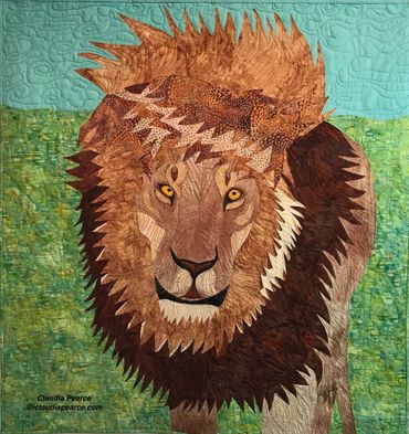 Quilt of a male lion with mane blowing in the wind.