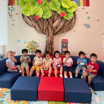 Group of toddlers sitting on couch