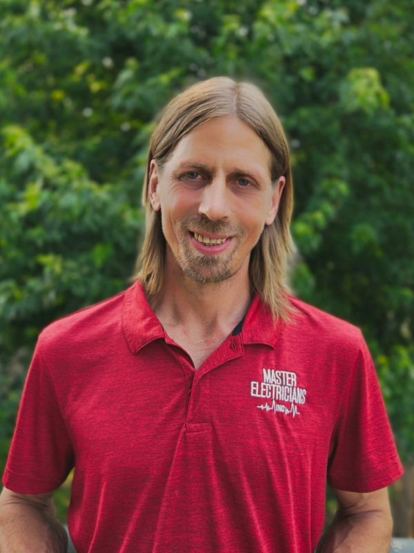 Man in red polo shirt with Master Electricians logo.