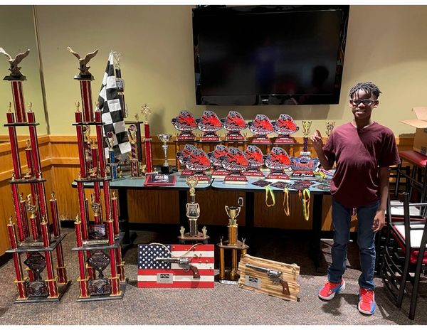 Cam Carraway shows his trophy collection from racing Quarter Midget, and Jr. Late Model Stock Cars.